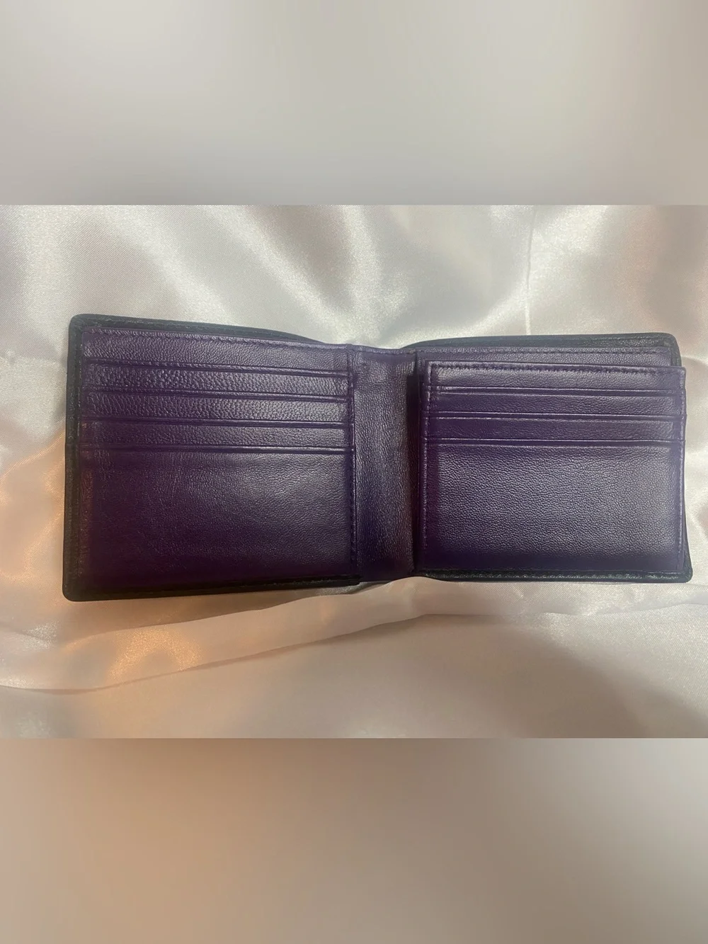 Classic Black Leather Bi-Fold Wallet with Subtle Embossed Logo